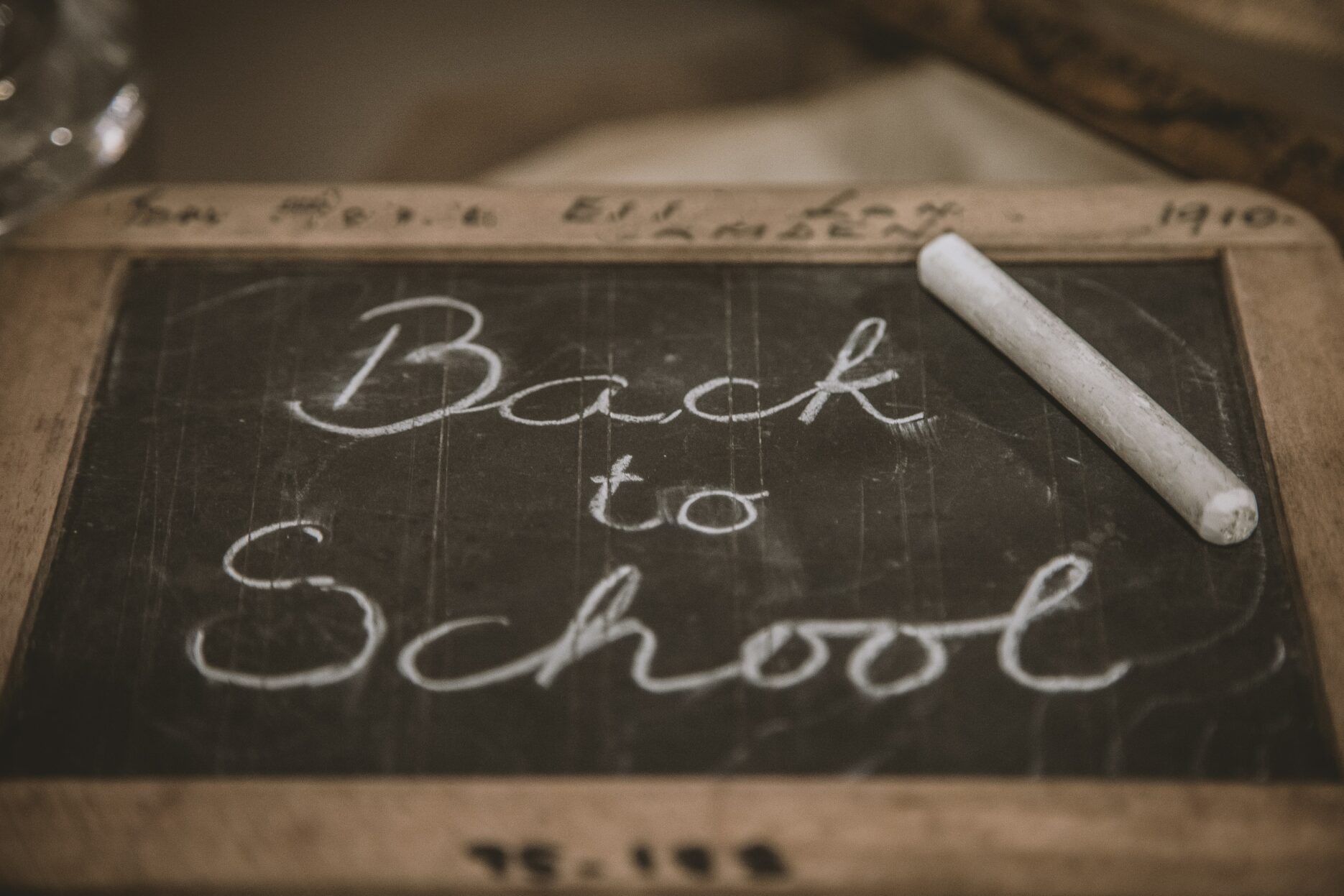 A photo of a chalkboard reads "Back to School" in white chalk cursive writing.