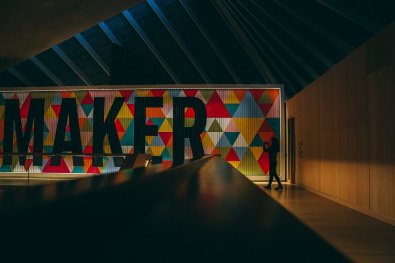 A carefully cropped wall to look like a piece of quilting that reads "Maker."