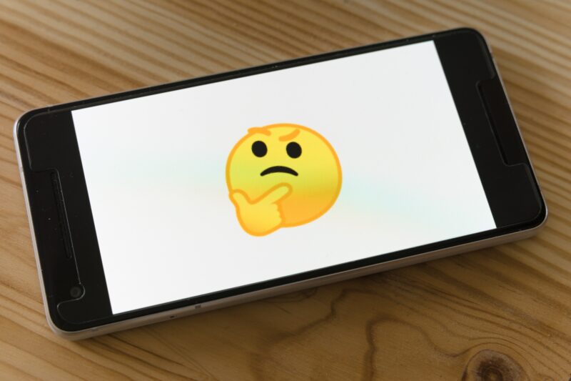 A quizzical emoji on a phone screen.